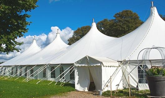 a row of blue portable restrooms waiting to be used at a special event in Boxford